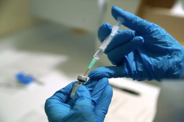 A needle is filled from a phial of Pfizer/BioNTech Covid-19 vaccine in Newcastle, UK