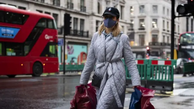 A shopper wears a face mask in London