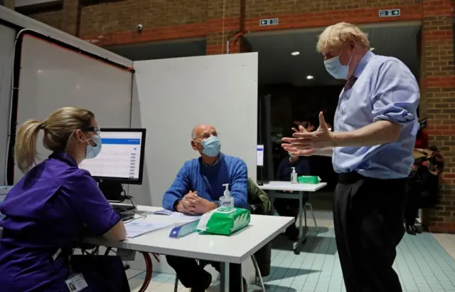 Prime Minister Boris Johnson gestures as he speaks to staff at Guy's Hospital in London