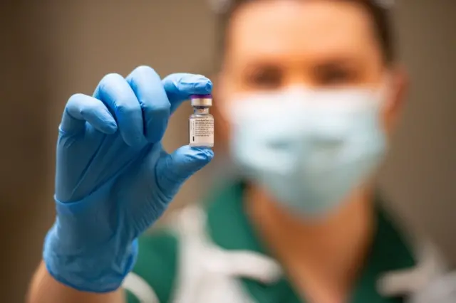 A nurse holds the Pfizer Covid vaccine in Coventry