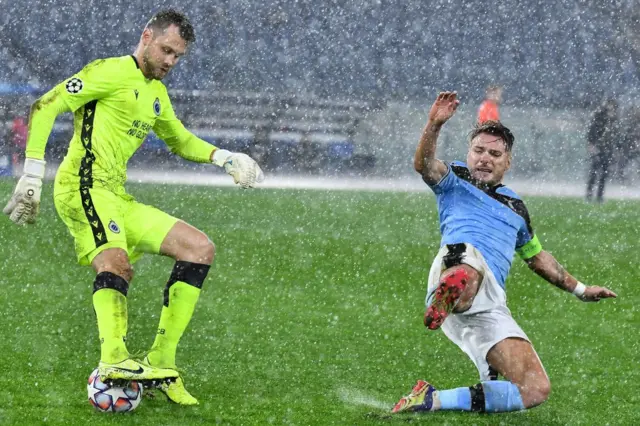 Ciro Immobile attempts a block in the rain