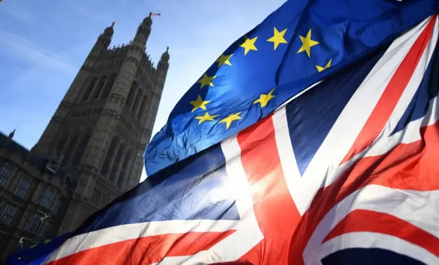 EU and UK flags outside parliament