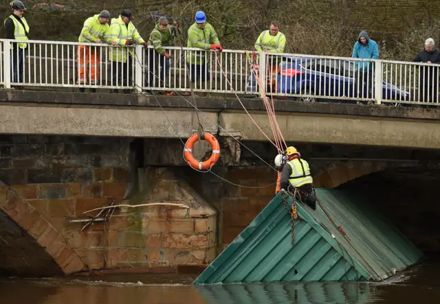 A shipping container trapped under the Rastick Bridge in Brighouse