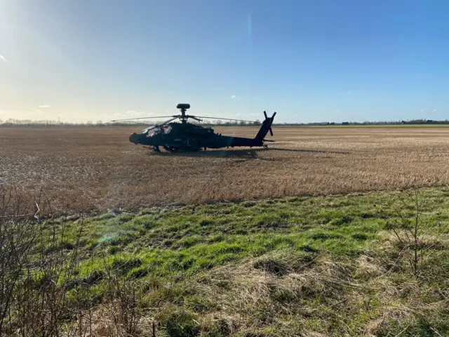 Apache Helicopter grounded in field