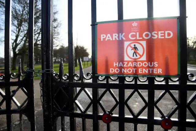 A closure sign on locked gates at Richmond Park