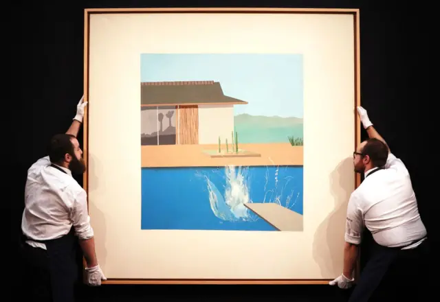 Sotheby's employees handle The Splash by David Hockney