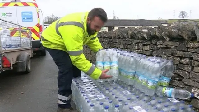 Man collecting bottled water