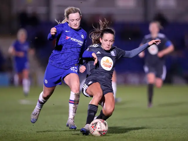 Lucy Staniforth of Birmingham City is challenged by Erin Cuthbert