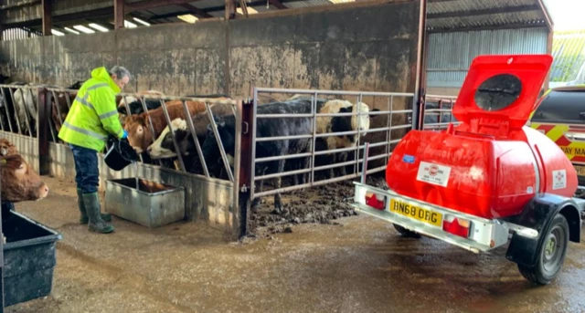 United Utilities employee Robert Wilson fills up cattle troughs for farmer