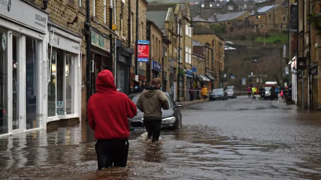 People in flood water in Hebden Bridge