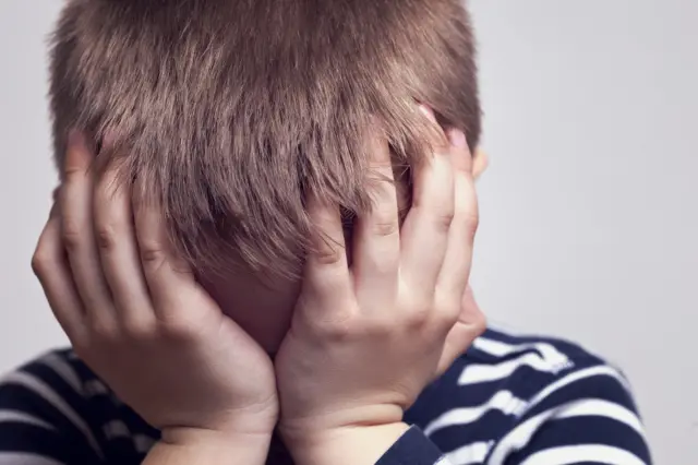 A child with his head in his hands