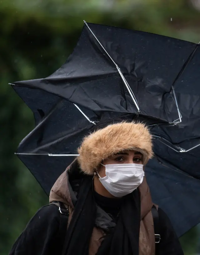 Woman with broken brolly