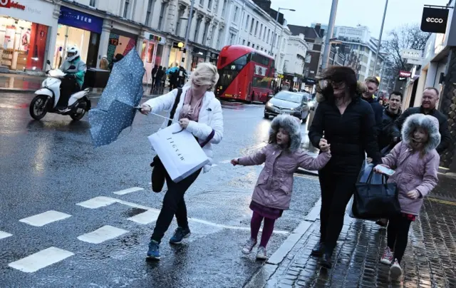 Woman wrestles with brolly