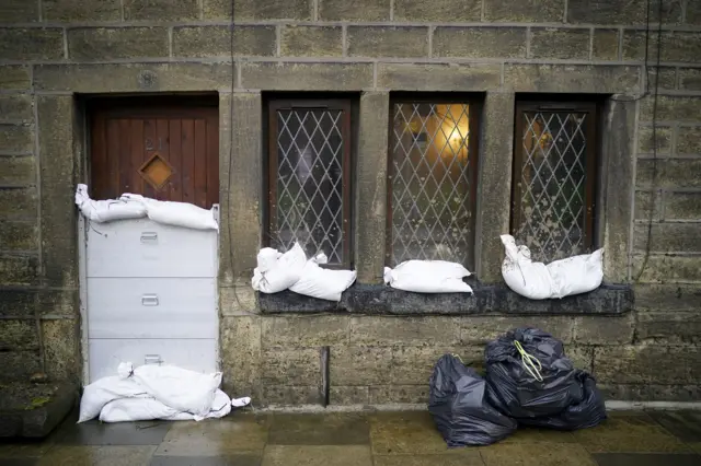 Mytholmroyd residents protect their homes with sandbags and other flood defences.