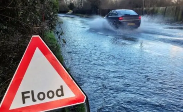 Car driving through flood water