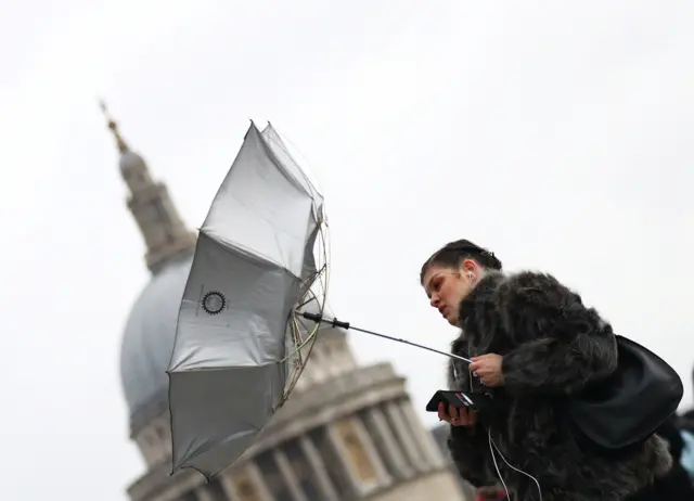 Woman with broken brolly