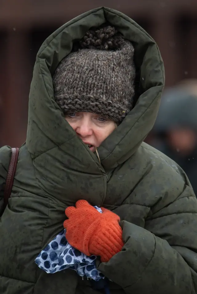 Woman wrapped up in coat