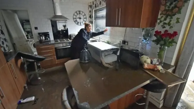 Caroline Jones inside her flooded home