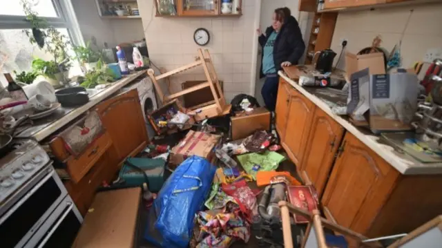 Rachel Cox inside her flooded home in south Wales