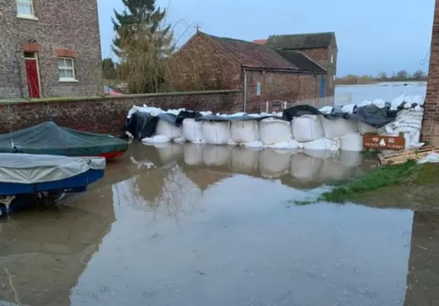 Sandbags keeping water back on the on the ferry slipway in Naburn