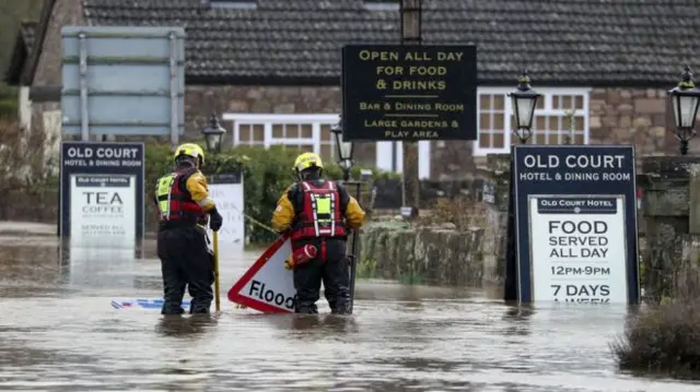 Image copyrightPA MEDIA Image caption Rescue workers in Whitchurch in Herefordshire