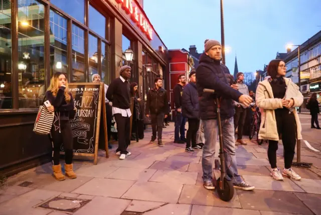 People watch the crime scene outside Streatham