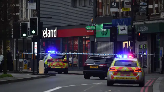 Police vehicles at the scene in Streatham High Road, south London after a man was shot dead by armed officers, with police declaring the incident as terrorist-related