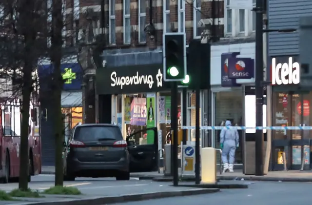 A police forensics officer near a site where a man was shot by armed officers in Streatham, south London