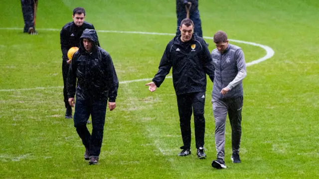 Steven Gerrard inspects the Ibrox pitch