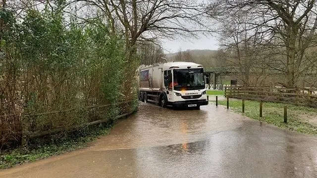 Bin lorry going through water