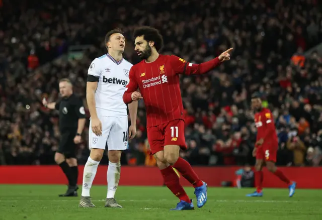 Mohamed Salah of Liverpool celebrates after scoring his sides second goal during the Premier League match between Liverpool FC and West Ham United at Anfield