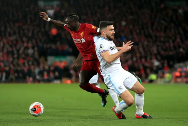 Liverpool's Sadio Mane (left) and West Ham United's Robert Snodgrass battle for the ball during the Premier League match at Anfield