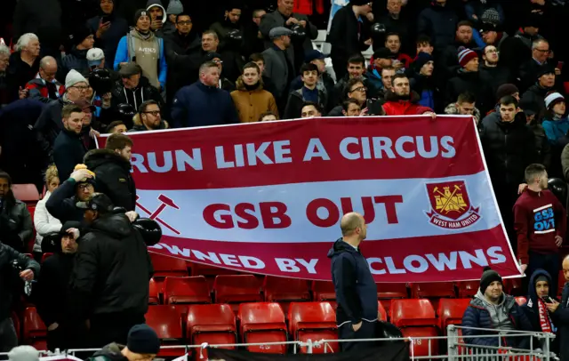 West Ham fans hold up a banner at Anfield