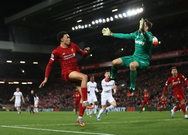 Trent Alexander-Arnold of Liverpool passes the ball past Lukasz Fabiaski of West Ham United for Sadio ManÃ© of Liverpool to scores his sides third goal during the Premier League match between Liverpool FC and West Ham United