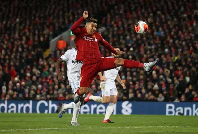 Roberto Firmino of Liverpool attempts a shot on goal during the Premier League match between Liverpool FC and West Ham United at Anfield