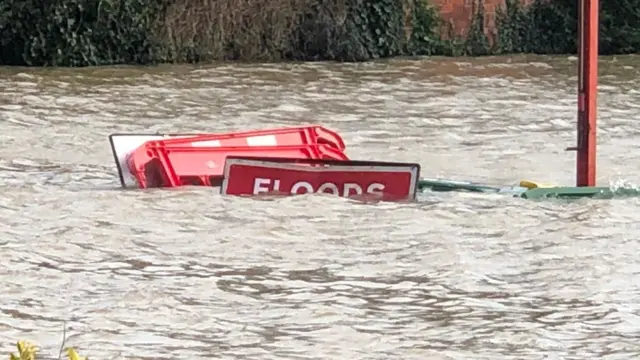 Flood warning sign almost underwate