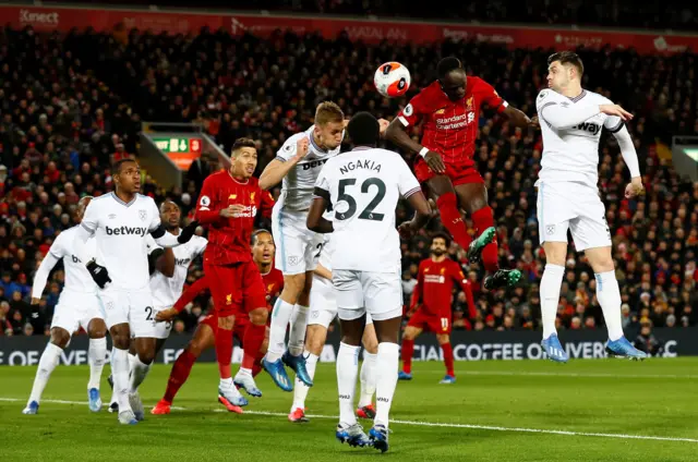 Liverpool's Sadio Mane in action with West Ham United's Aaron Cresswell and Tomas Soucek