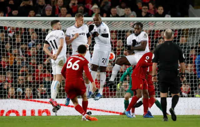 Liverpool's Trent Alexander-Arnold shoots at goal from a free kick