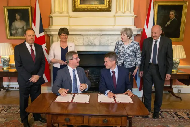 Members of the DUP and the Conservative party sign the confidence and suppy deal in 2017