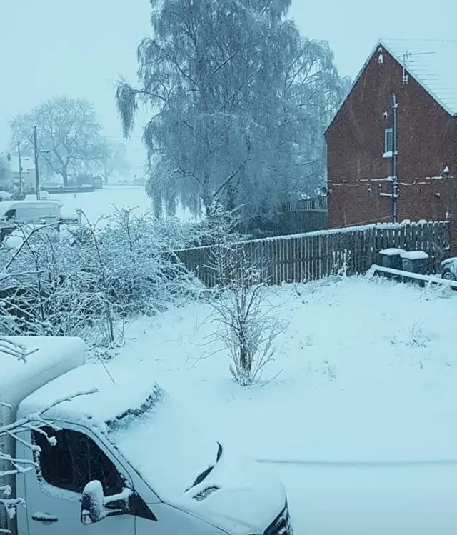 Snow on cars and houses