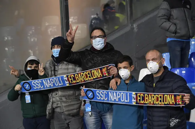 Fans wear protective masks at the Napoli v Barcelona game