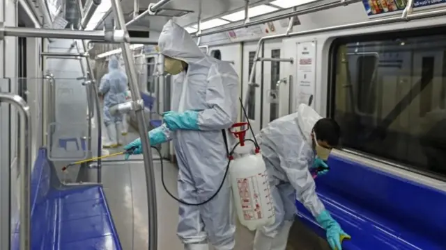 Iranian municipality workers spray disinfectant as a precaution against COVID-19 at a wagon of Tehran"s public subway in Tehran, Iran, 25 February 2020