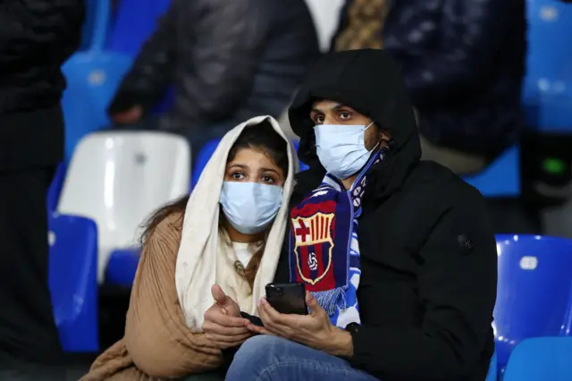 Fans wear protective masks at the Napoli v Barcelona game