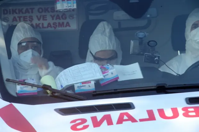 Medics arrive to meet people from a Turkish Airlines flight arriving in Ankara, Turkey, 25 February 2020.