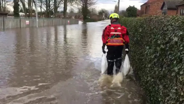 Firefighter with sandbags