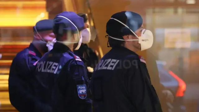 Police officers at the hotel wearing protective masks in Innsbruck