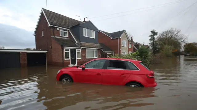 A damaged car and house