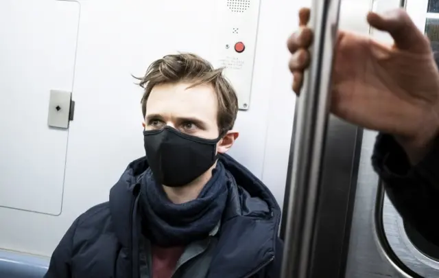 A man wears a face mask on the New York subway