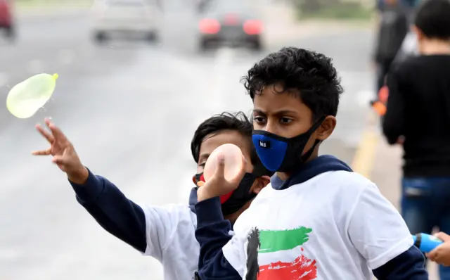 Children wearing masks in Kuwait