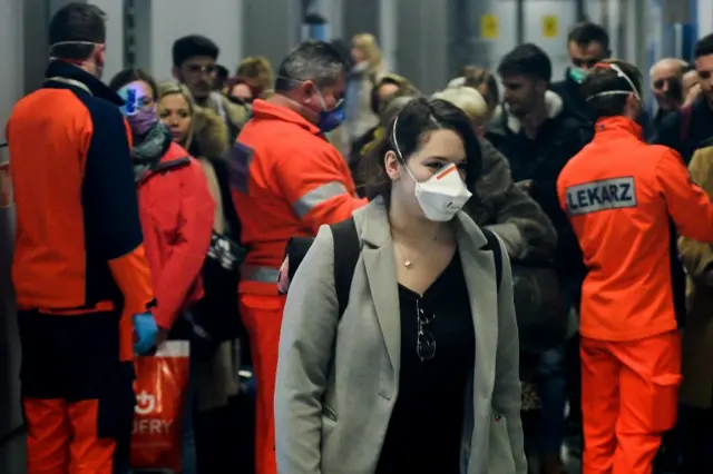 A passenger wears a mask at Krakow International Airport